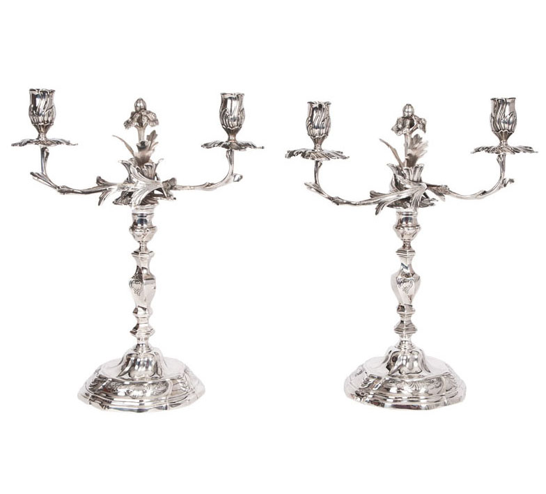 A splendid pair of Rococo style candlesticks