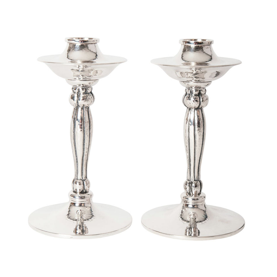 A pair of hammered candle sticks