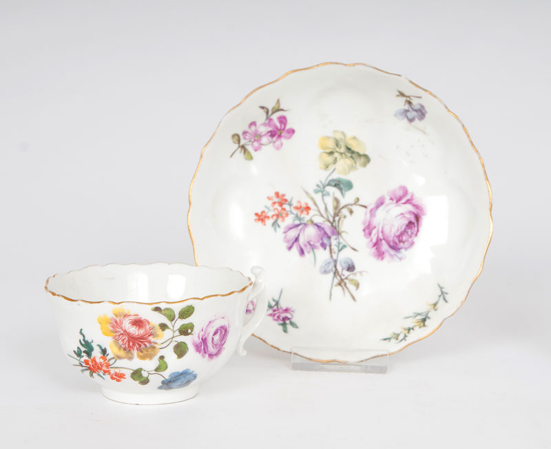 A cup and saucer with floral decoration