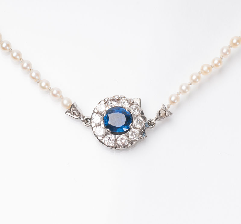 A pearl necklace with sapphire diamond clasp