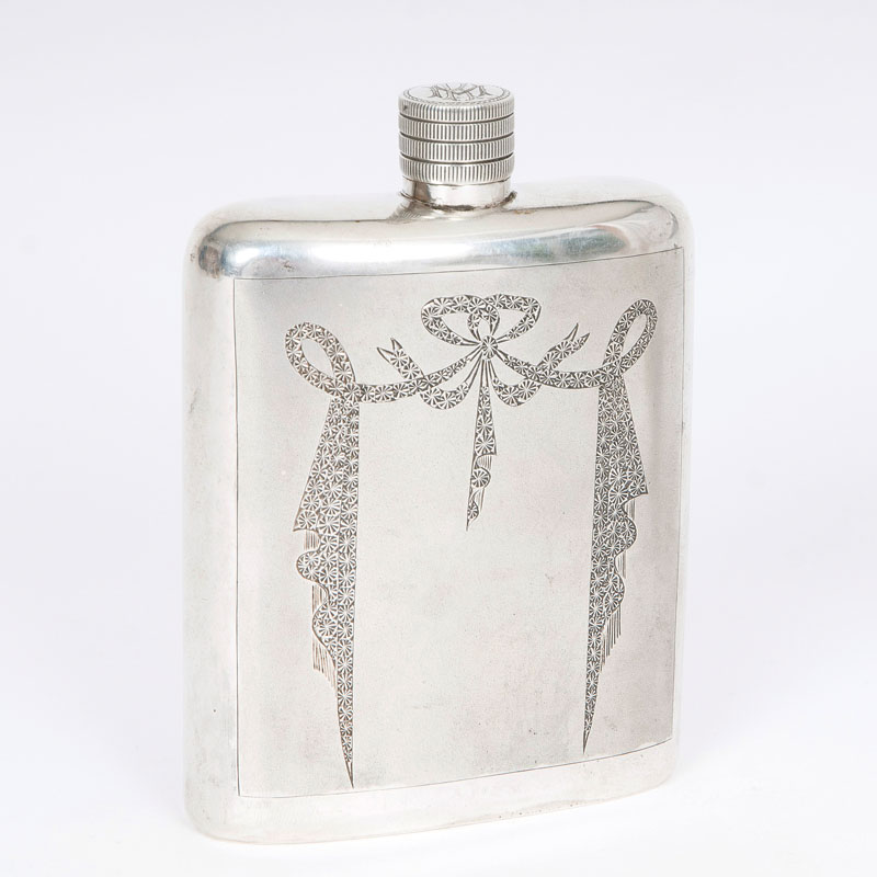 A hip flask with engraved pattern