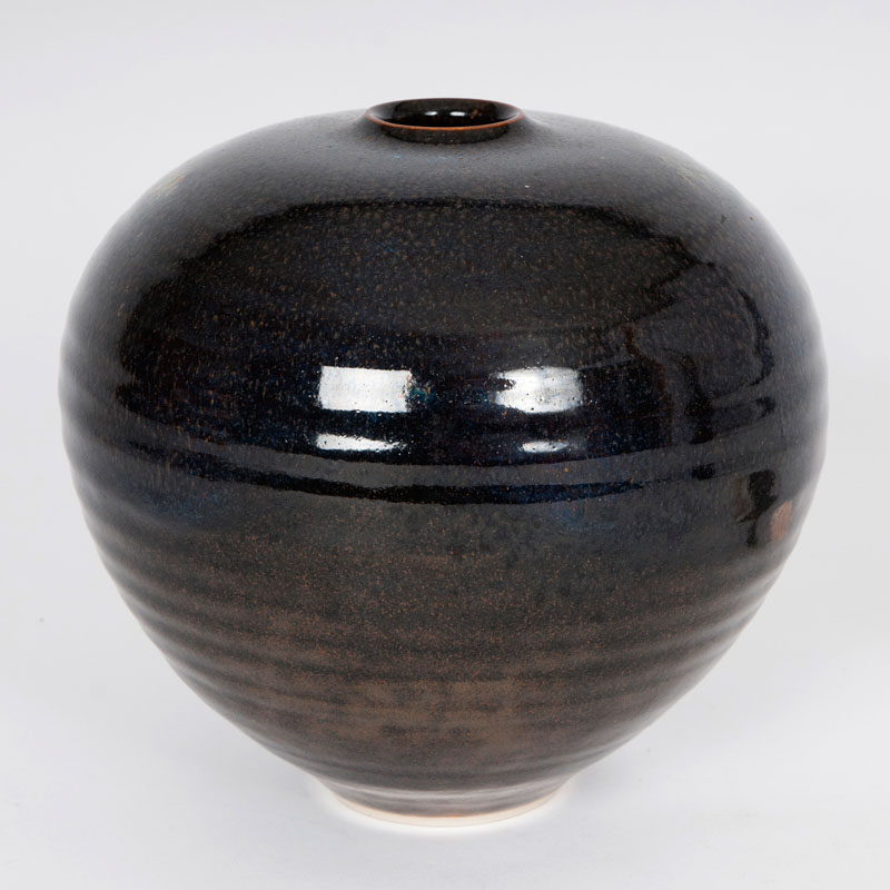A rounded vase with fur glaze