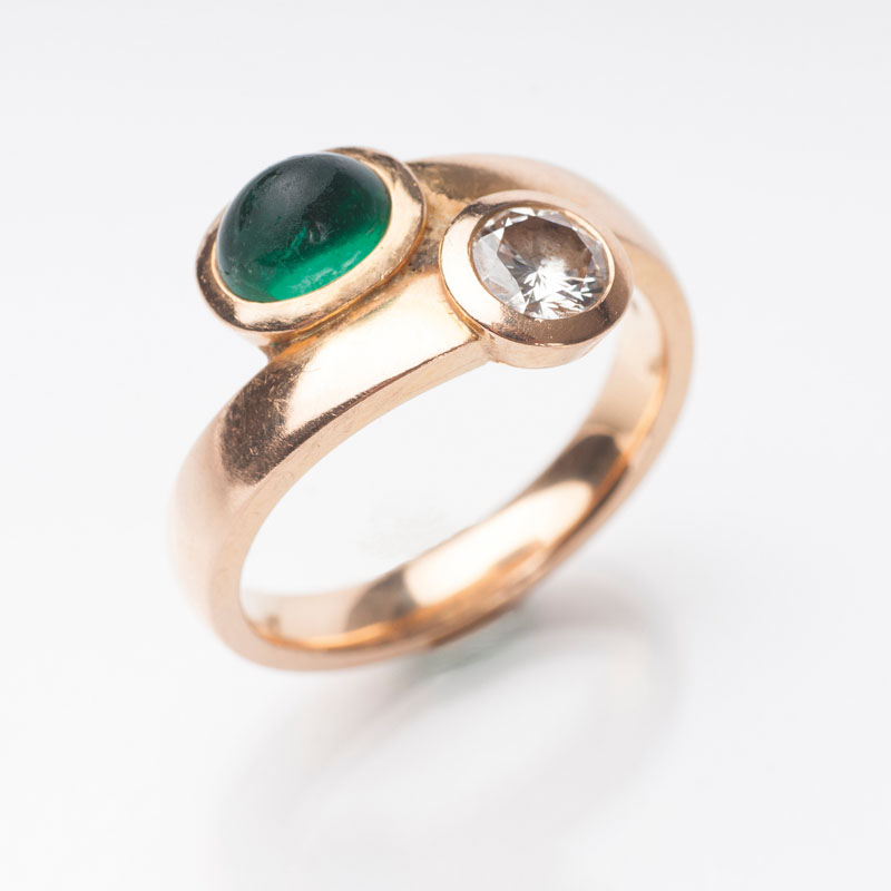 An emerald diamond ring