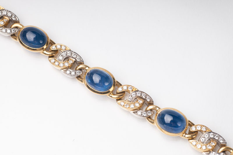 A gold necklace with sapphires and diamonds