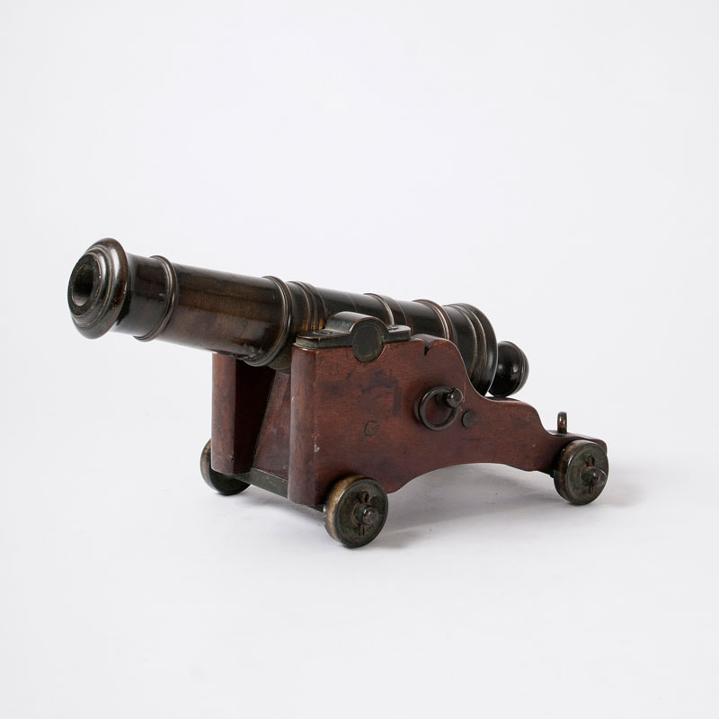 A miniature ship cannon on a wooden carriage