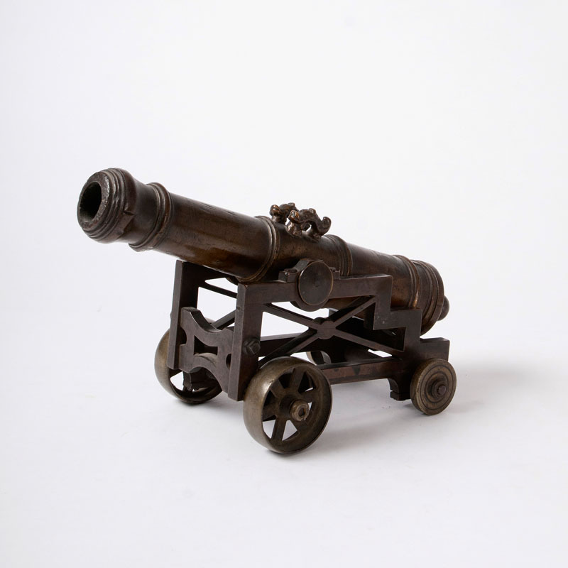 A miniature ship cannon on a bronze carriage