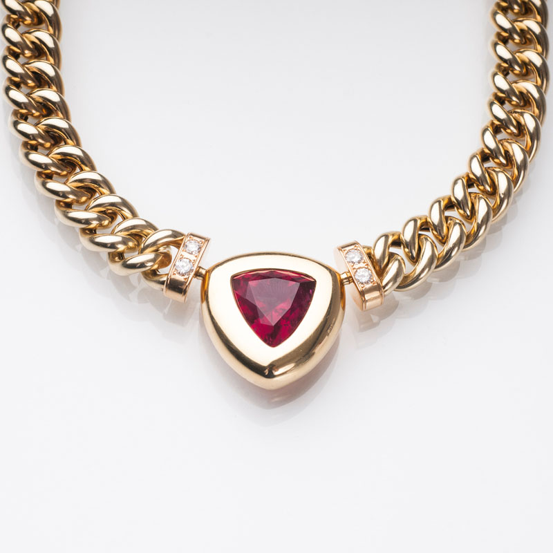 A gold necklace with diamonds and tourmalin clasp