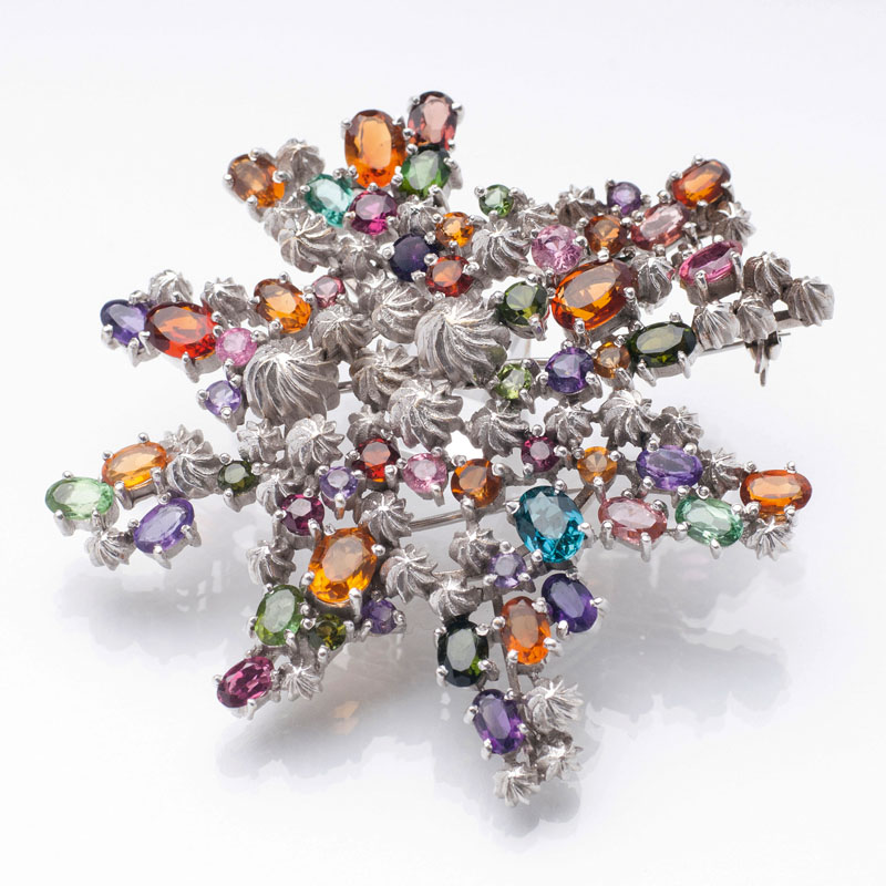 A flower brooch with precious stones