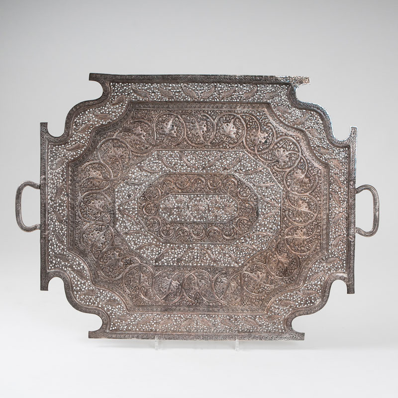 A decorative serving tray with rich openwork