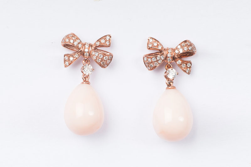 A pair of coral diamond earrings
