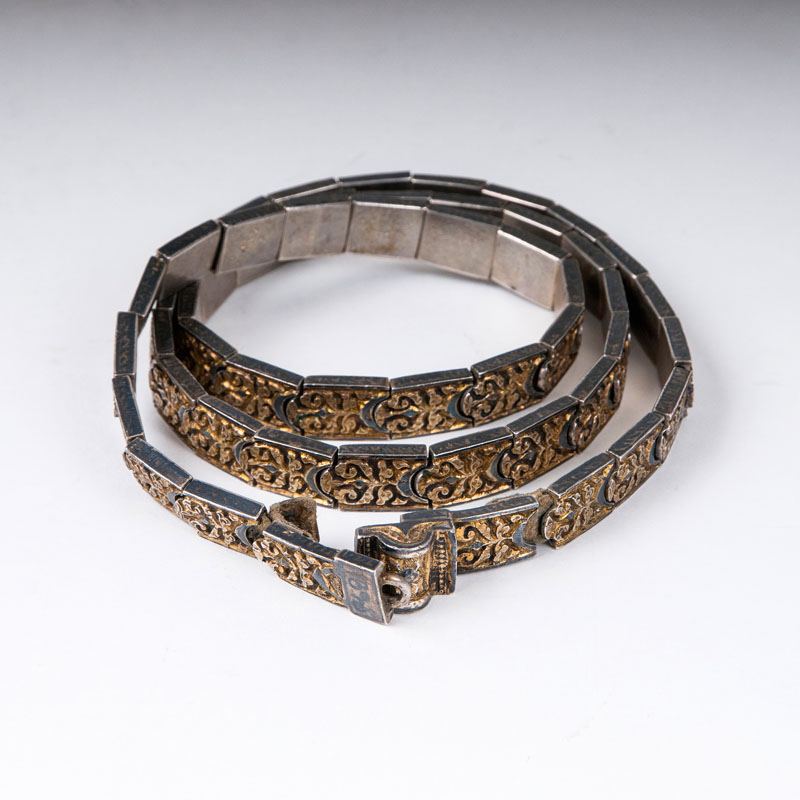 A gilded belt with floral relief pattern