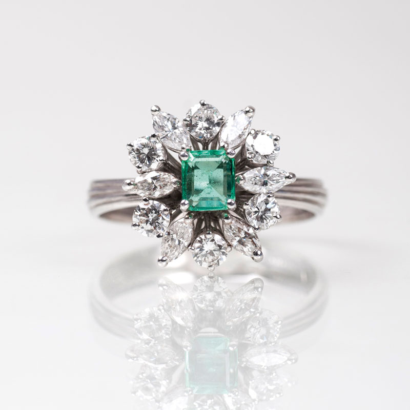 An emerald diamond ring