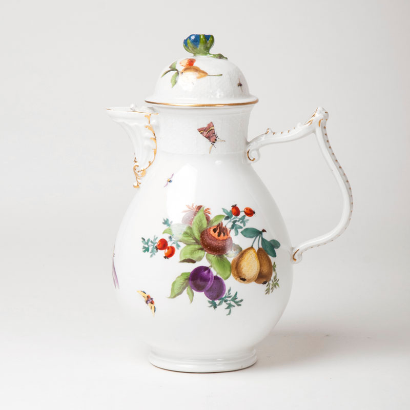 A coffee pot with fruit decor