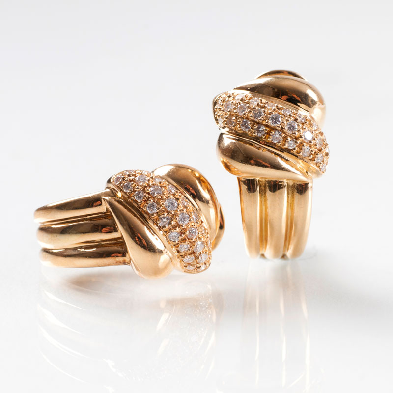 A pair of ear clips with diamonds