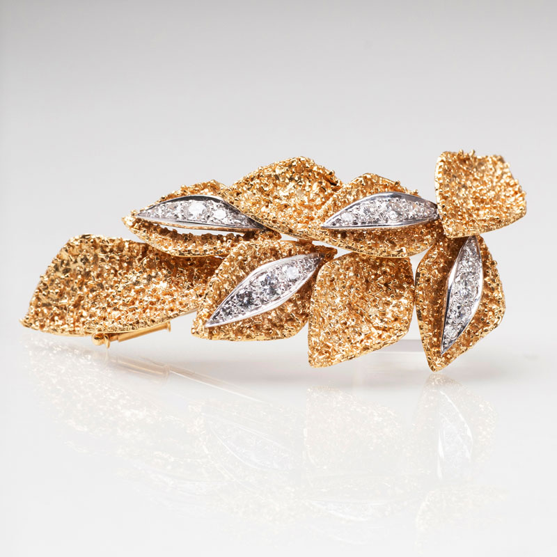 A goldenvintage  brooch with diamonds