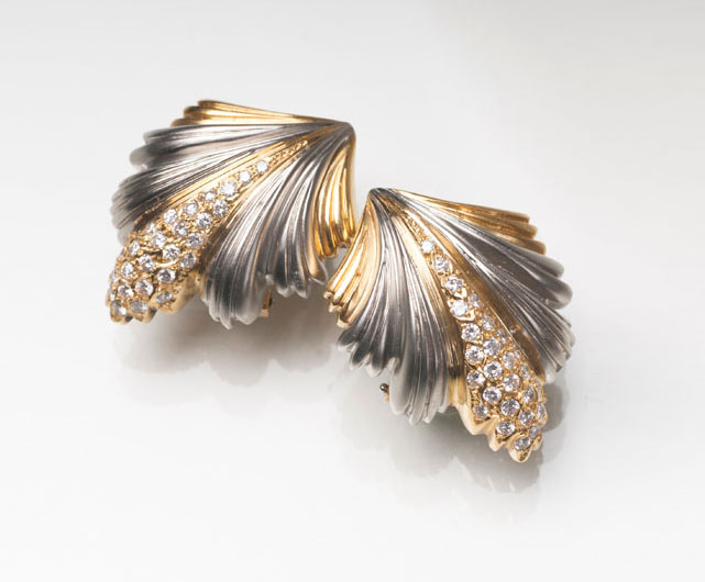 A pair of leaf shaped earclips with diamonds