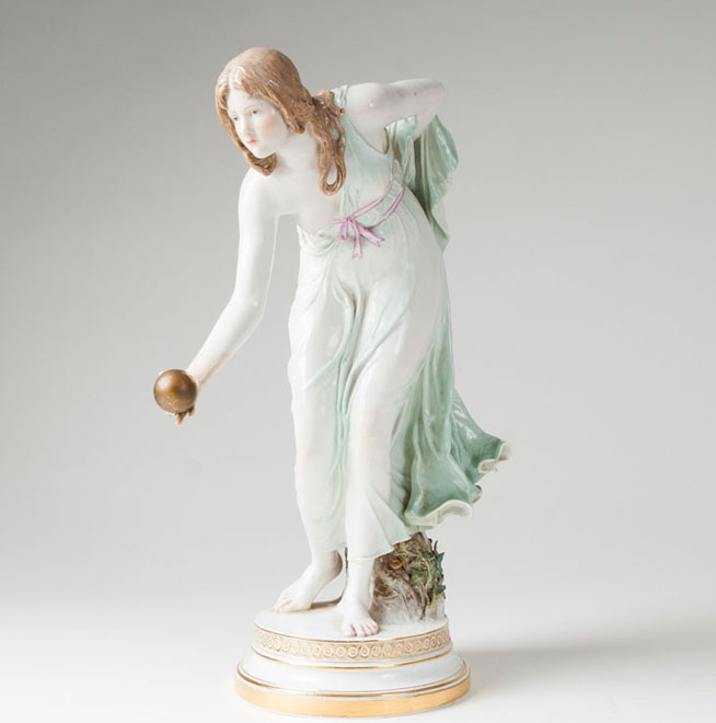 A porcelain figure 'tall female ball player'