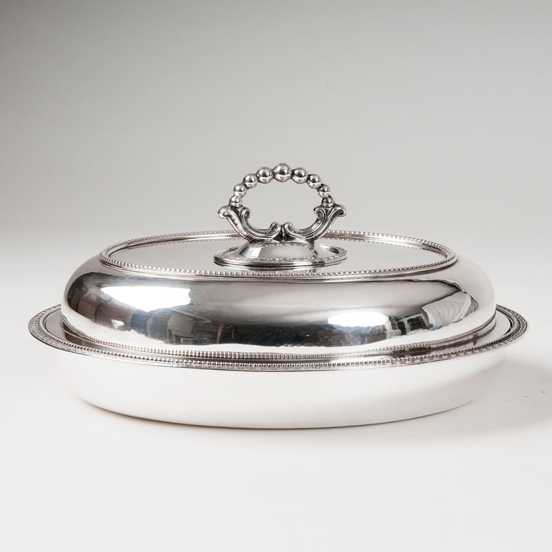 An oval serving bowl by Comyns & Sons