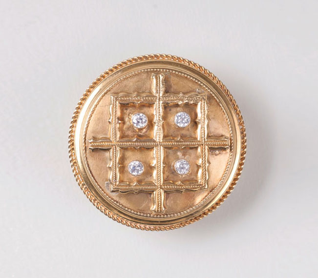 A golden brooch with diamond setting