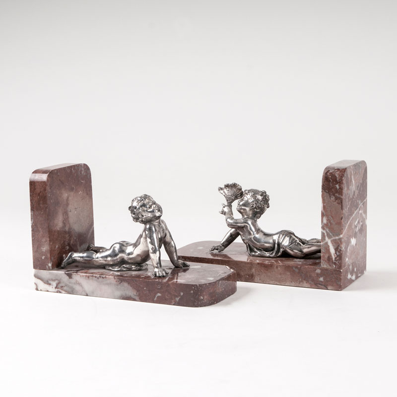 A pair of decorative bookends with putti