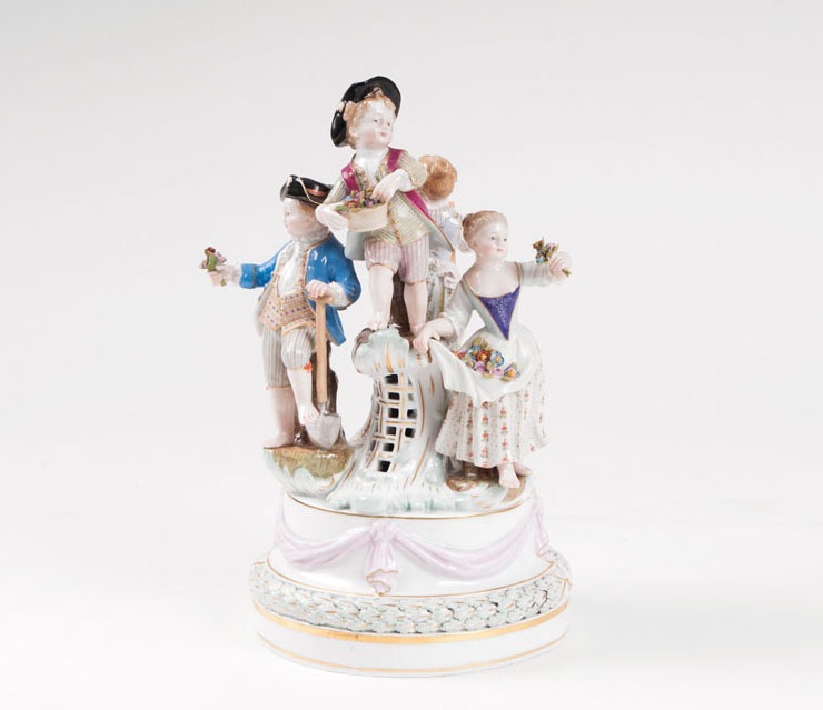 A porcelain group '4 children as gardeners'