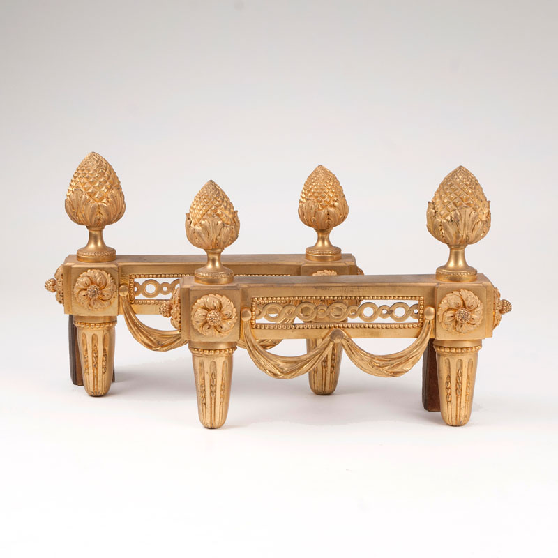 A pair of gilded firedogs of Louis Seize style