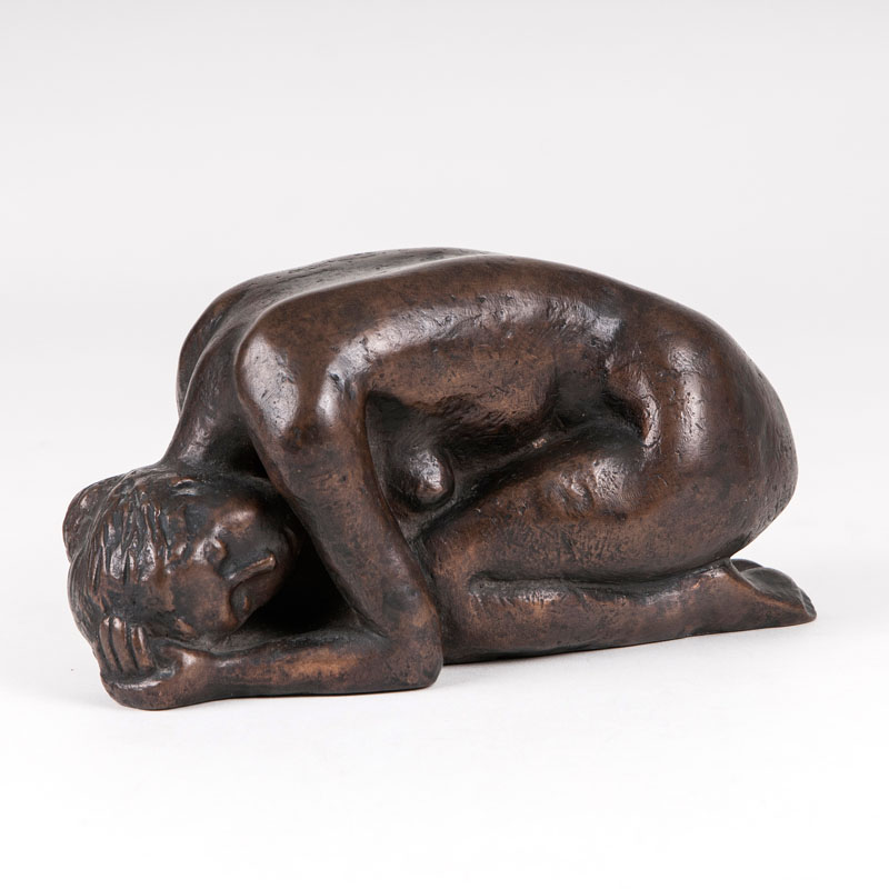 A bronze sculpture 'a squatting female nude'