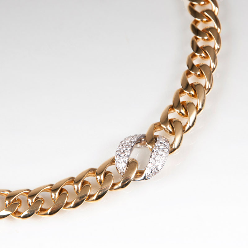 A gold necklace with diamonds