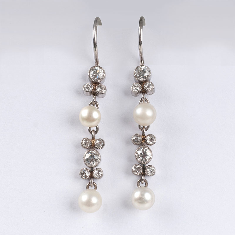 A pair of petite seedpearl earrings with old cut diamonds
