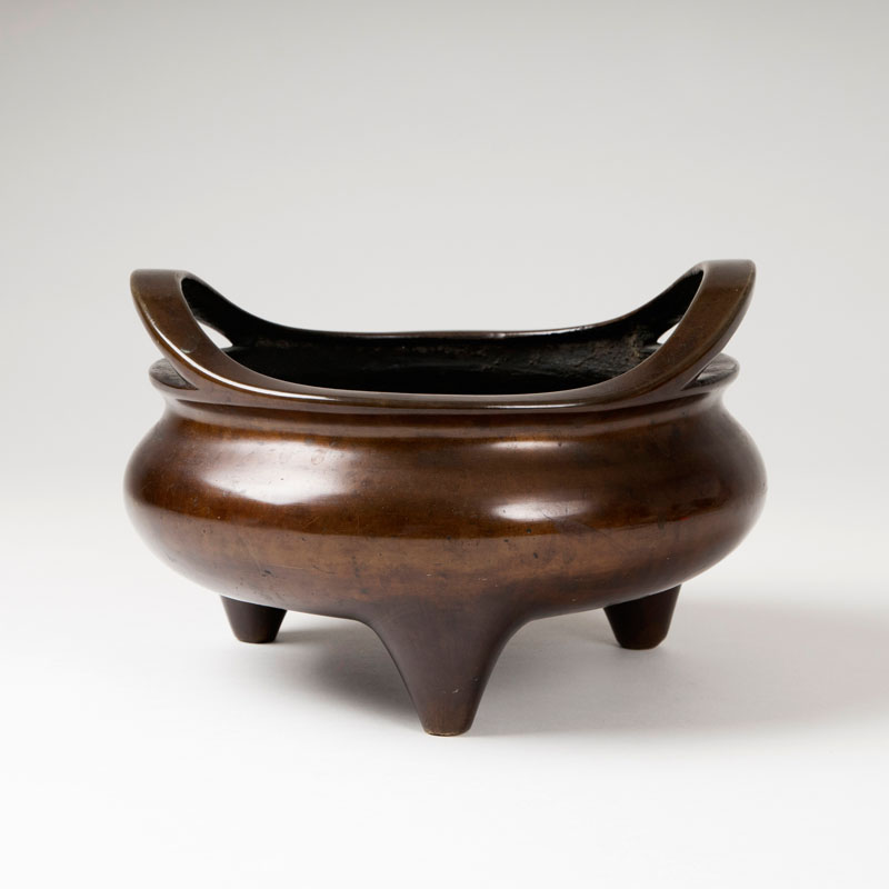 A bronze tripod censer