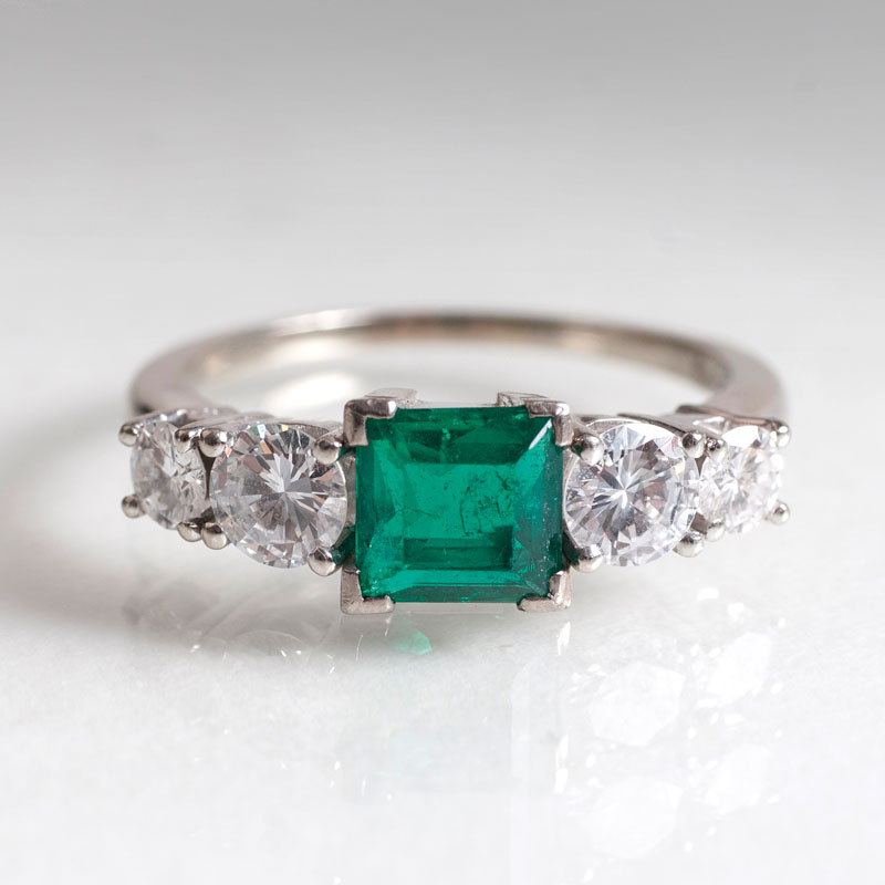 An emerald diamond ring