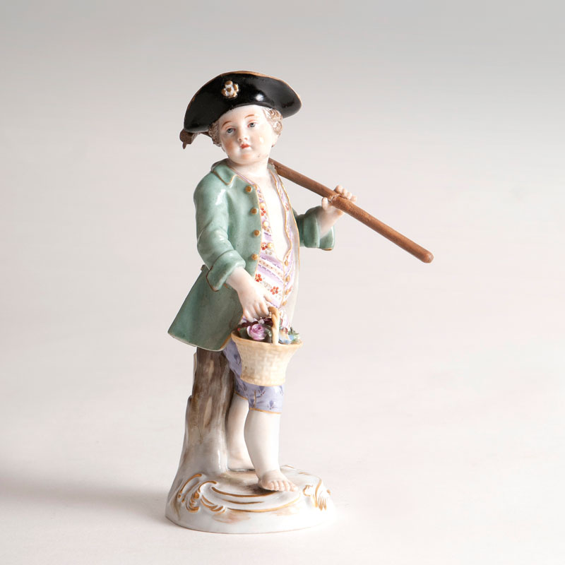 A porcelain figure 'Gardener Child with Rake'