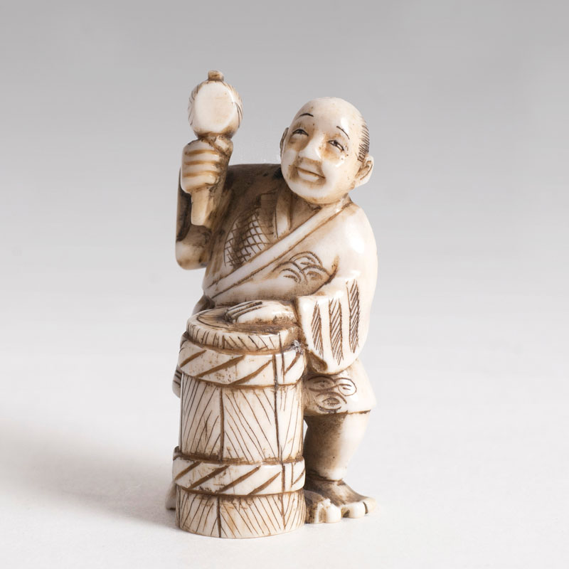 An ivory-netsuke 'barrel maker'