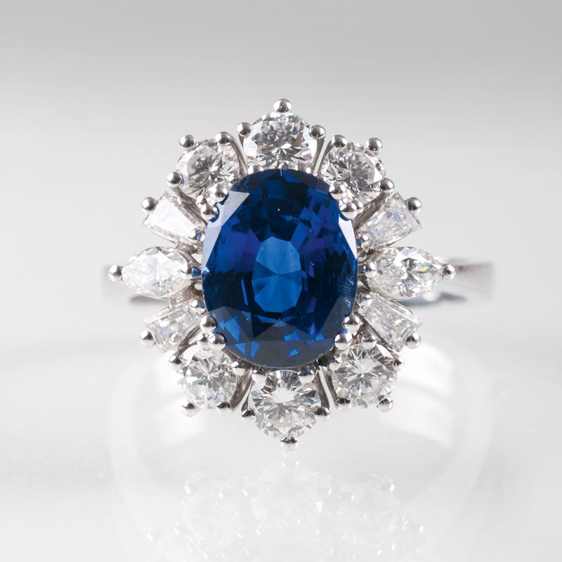 A platinum ring with one natural sapphire and diamonds