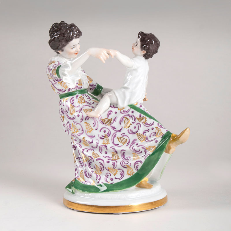 A porcelain figure 'Mother playing with her child'