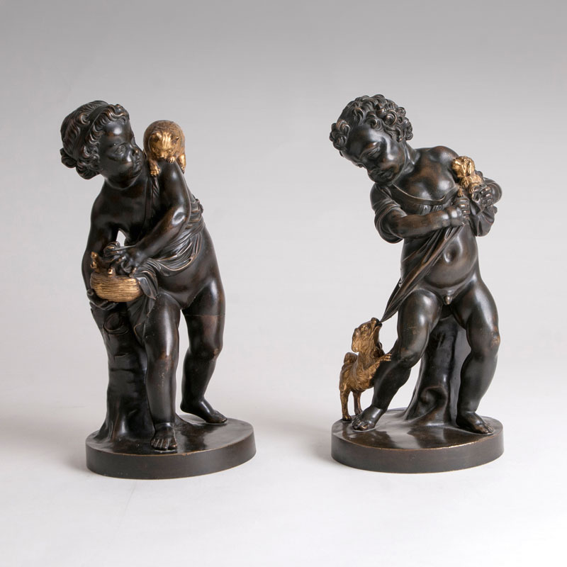 A pair of decorative bronze sculptures 'putti with dog and cat'