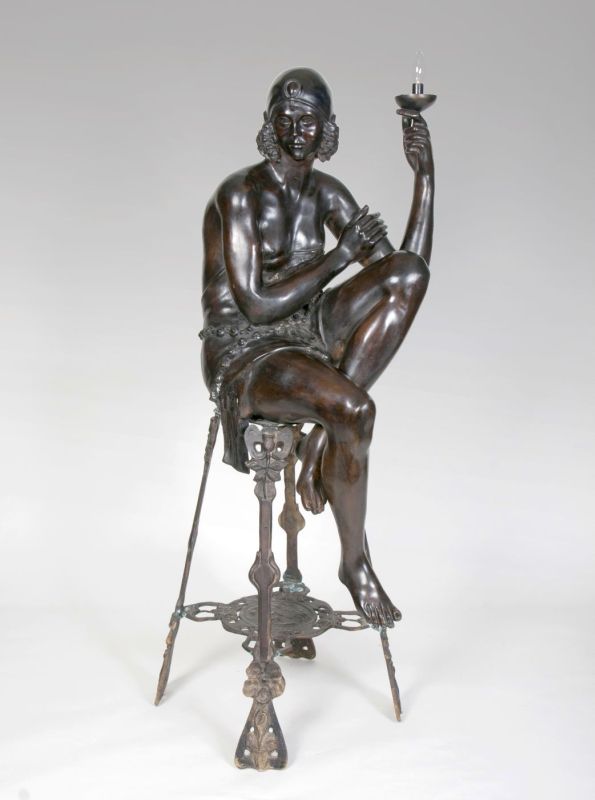 A large figurative bronze lamp in art déco style