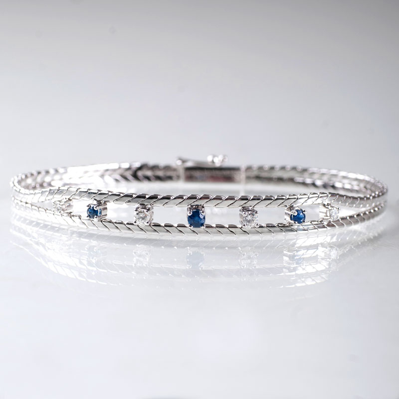 A petite golden bracelet with sapphires and diamonds