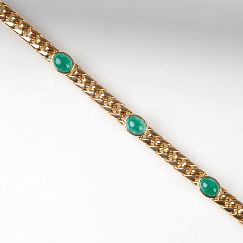 A curb chain bracelet with emeralds
