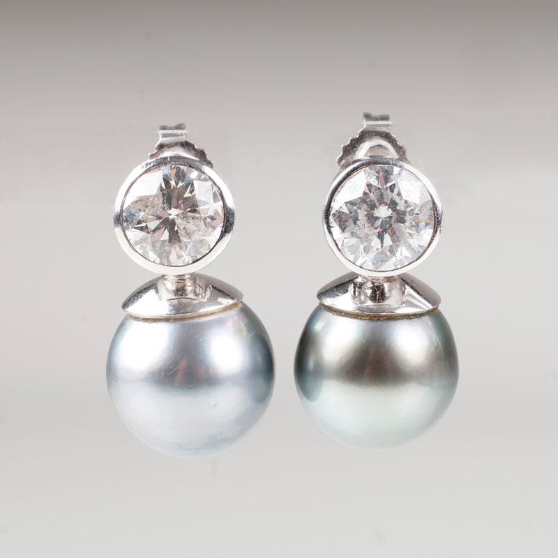 A pair of Tahiti pearl earrings with highcarat solitaire diamonds