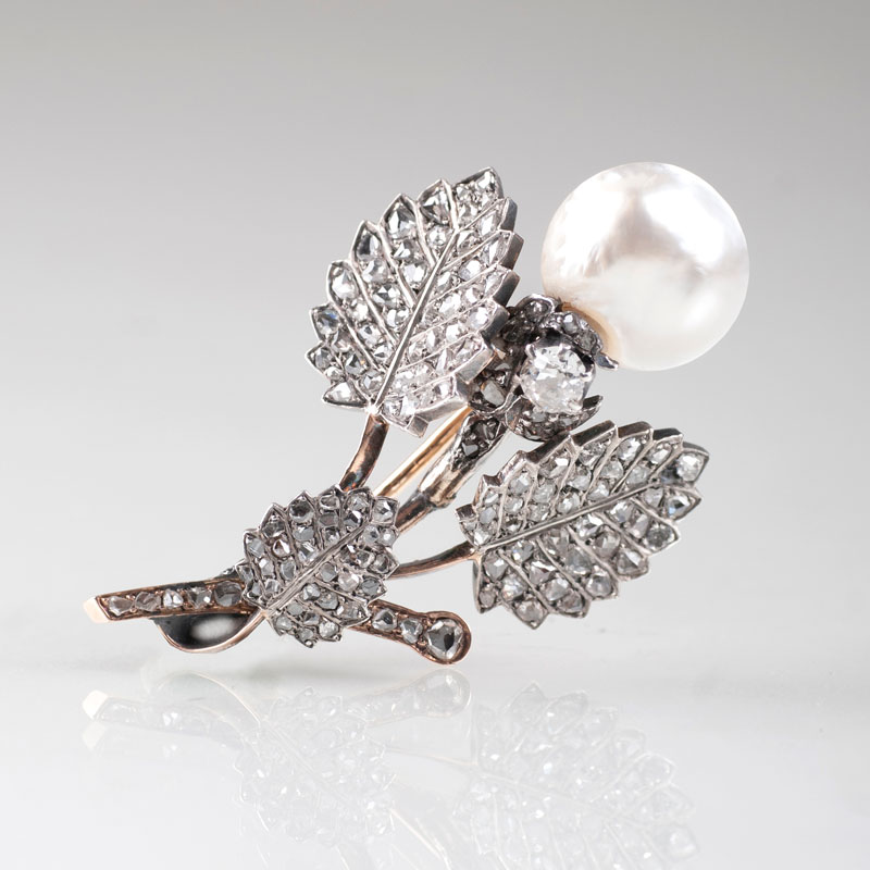 An antique flower brooch with diamonds and pearl