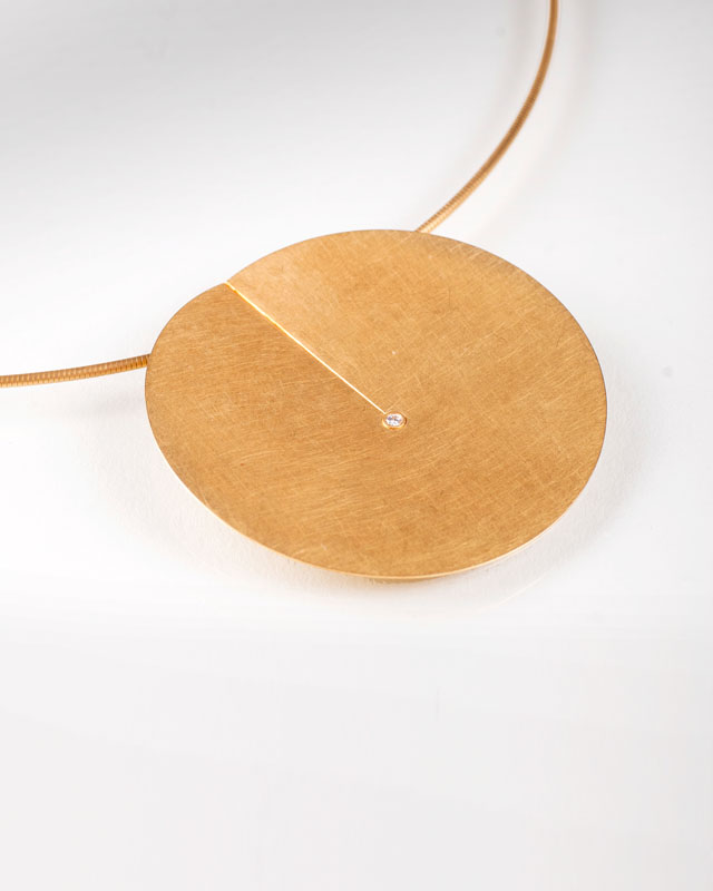 A golden necklace with small diamonds by Niessing
