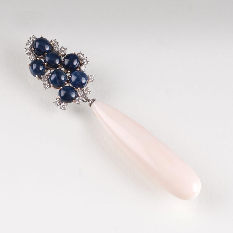A large coral pendant with sapphires and diamonds