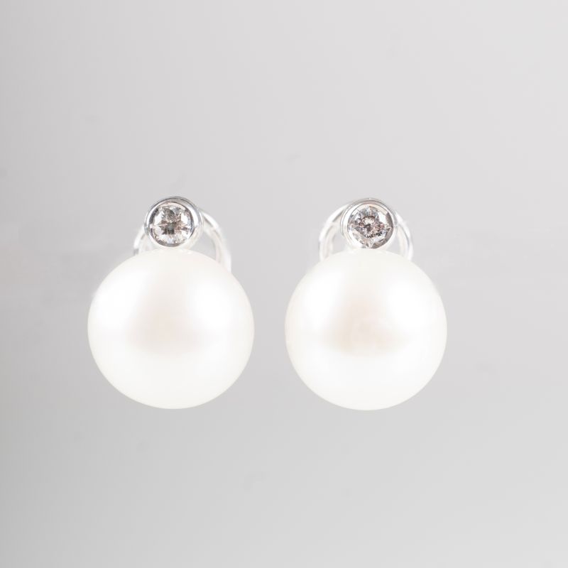 A pair of Southsea pearl earstuds with solitaire diamonds