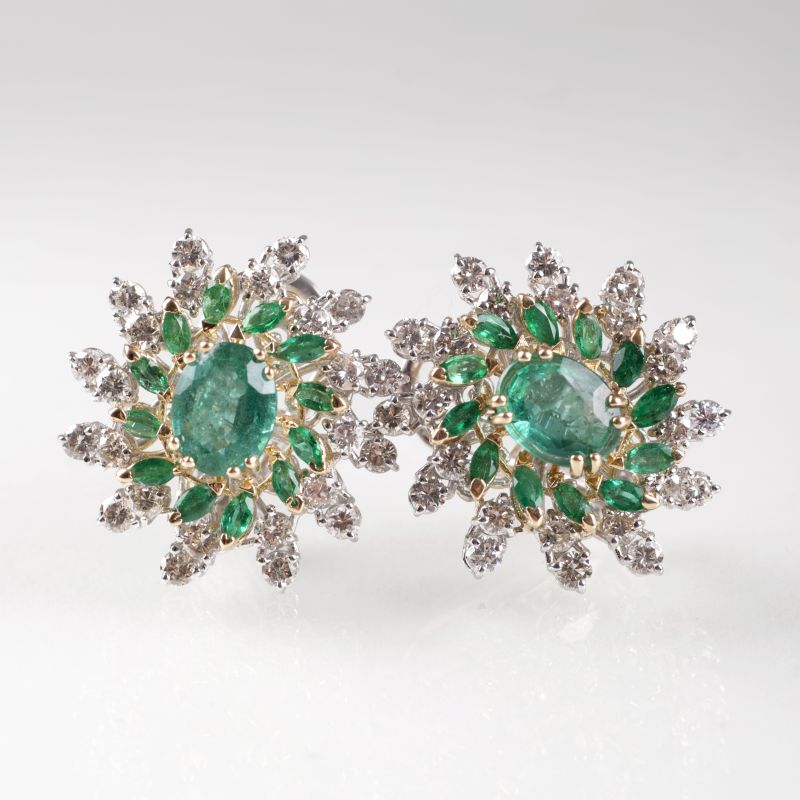 A pair of flower earrings with emeralds and diamonds