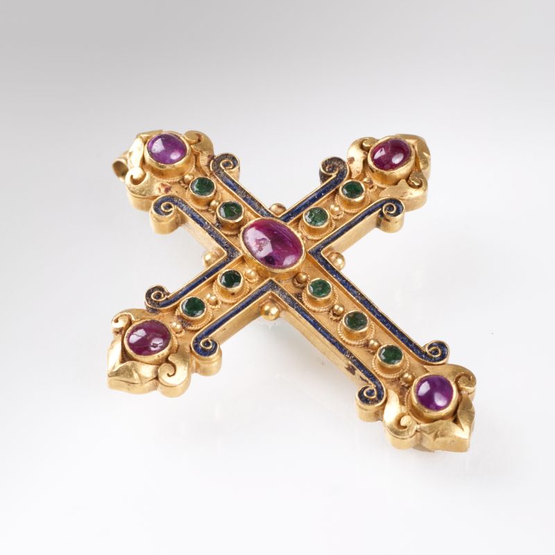 A golden cross pendant with rubies and emeralds