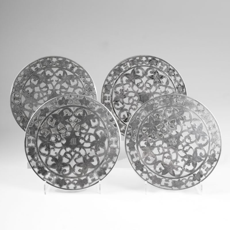 A set of 4 plates with floral overlay decor.