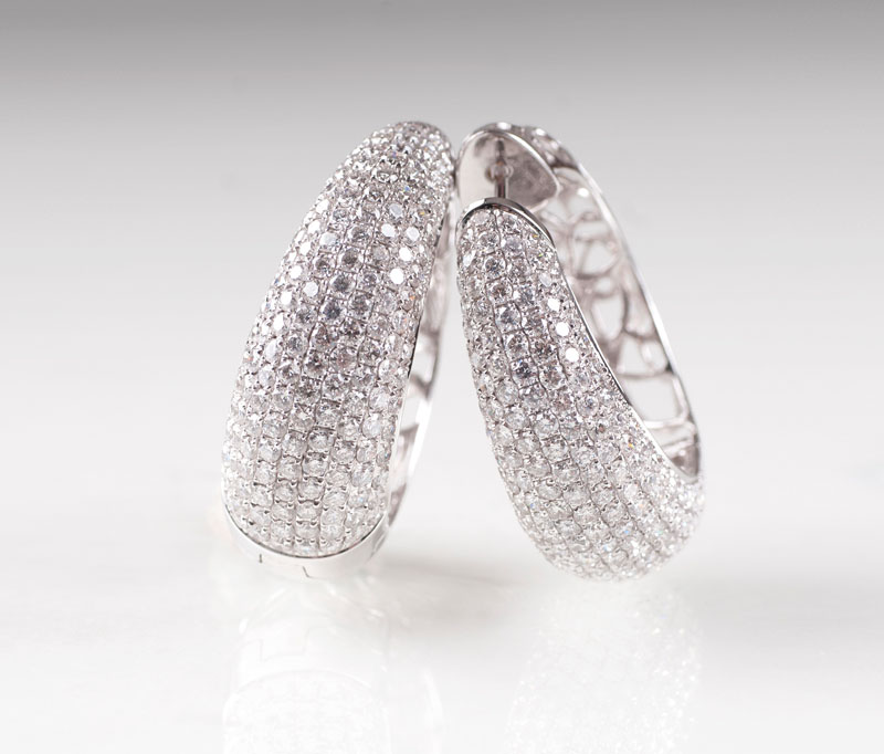 A pair of high carat diamond earrings