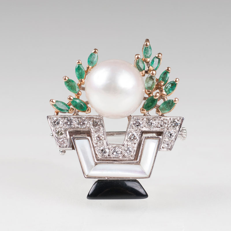 An emerald pearl diamond brooch with mother-of-pearl and onyx in Art Déco style