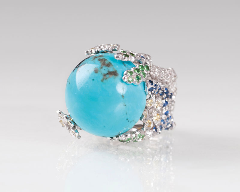 A turquoise sapphire diamond ring with floral design